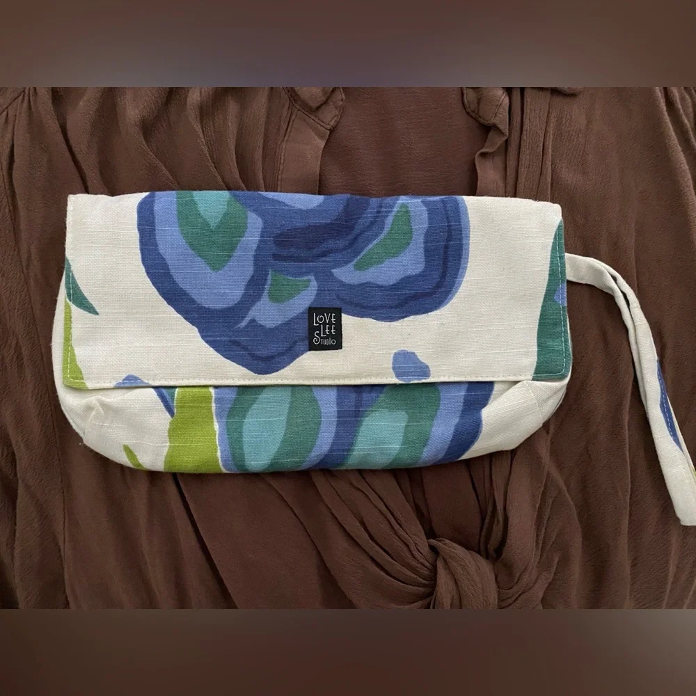 Linen textured floral fabric clutch w wrist strap small maker brand